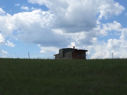 Old boxcar against a western sky.