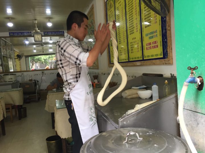 Making noodles at a street side shop. 