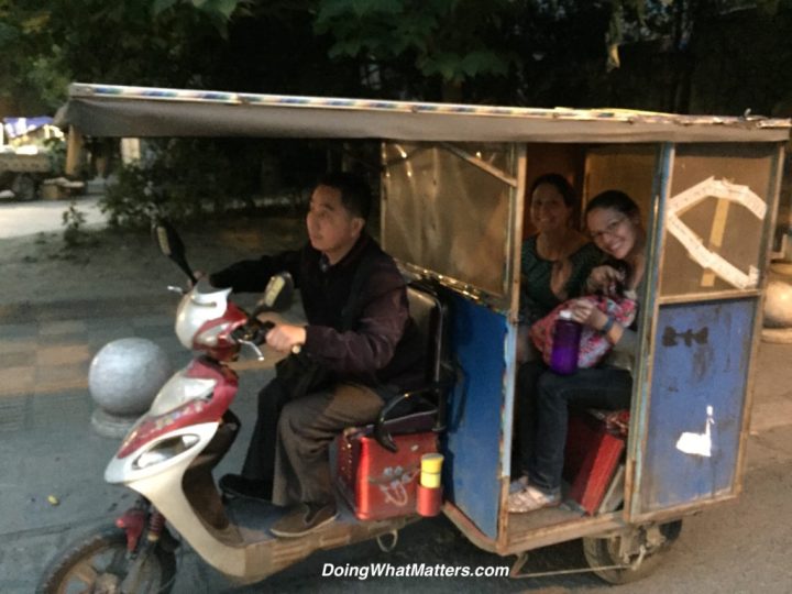 Riding home in a san lun che — a three-wheeled vehicle.