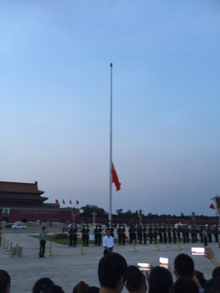 Tiananmen Square flag lowering scene.
